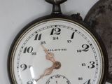 an old pocket watch sitting next to an old pocket watch