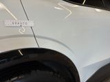 a sticker on the side of a white car