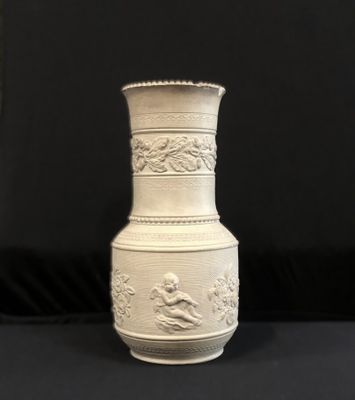 a white vase that is sitting on a black table