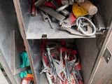 a metal cabinet with tools in it on the floor