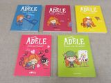 several children ' s books are lined up on a table