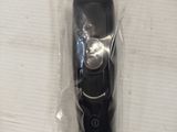 an image of a black electric shaver on a white table