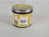 a close up of a jar of cream on a white surface