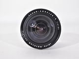 a close up of a camera lens on a white surface