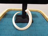 a picture of a ring on a stand on a blue mat