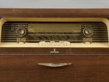 an old fashioned radio sitting on top of a wooden dresser