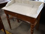 a marble top table with a drawer underneath it