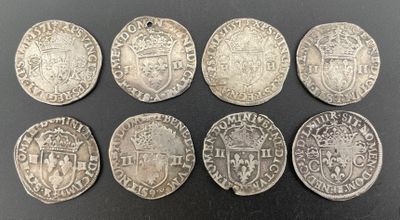 six silver coins of different sizes and shapes on a black surface