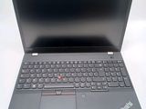 the laptop is open on a white surface with a black keyboard