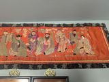 a picture of a wall hanging with a group of people on it