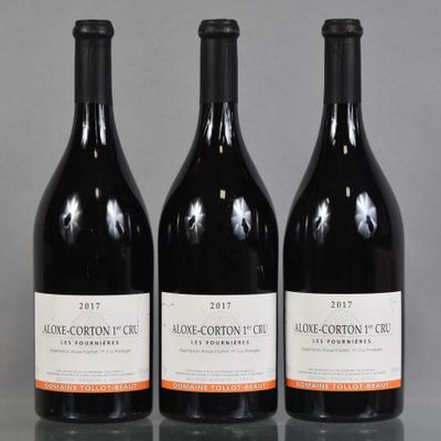 three bottles of wine are lined up on a table