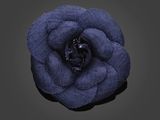 a blue flower with a black center on a black background