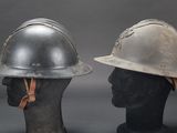 pair of helmets on mannequin heads on grey background