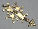 a gold star shaped pendant with a bird on it