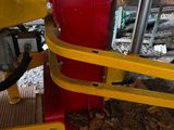 a red and yellow machine that is on the ground