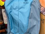 a blue backpack sitting on top of a cardboard box