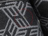 someone is wearing a pair of black and white slippers with a red circle in the middle of them