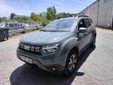 the front end of a green dacia parked in a parking lot