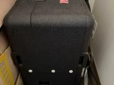 a black suitcase sitting on the floor next to a pile of boxes