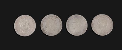 four different types of silver coins on a black background
