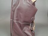 a bag that is sitting on the ground next to a suitcase