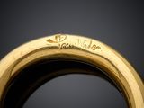 an image of a close up of a gold ring on a black surface