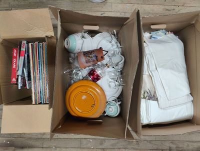 two boxes with items in them sitting on the floor