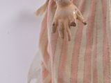 a doll that is holding a knife in her hand
