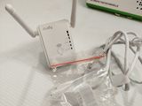 a white box on the bed with a wireless device on it