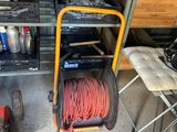 a cart that has a hose on it in a garage