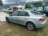 a silver car that is sitting in the grass