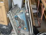 a pile of assorted items in a garage