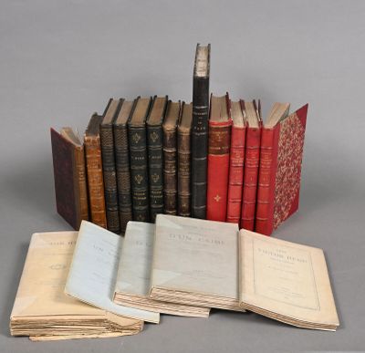 several old books are stacked on top of each other on a table