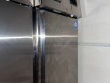 a stainless steel refrigerator in the corner of a kitchen