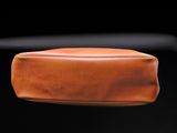 a close up of a brown leather seat on a motorcycle