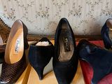 several pairs of women ' s shoes sitting on top of boxes on a floor