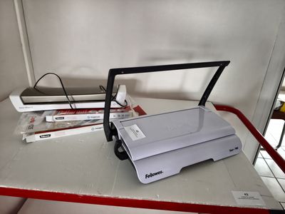 a white printer sitting on a table next to a stack of books