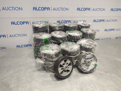a pile of tires sitting on top of each other in front of a wall