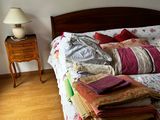 a bed that has a lot of clothes on it