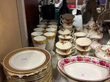 a lot of plates and bowls on the counter