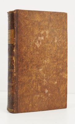 an old book sitting on top of a table next to a white background