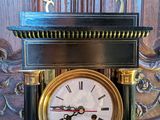 a black and gold clock sitting on a table