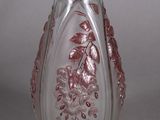 a glass vase that has a pink design on it