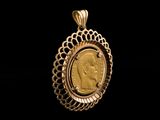 a close up of a gold coin in a pendant on a black background