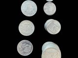 six different types of coins are shown on a black background