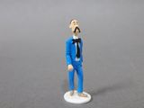 a small figurine of a man in a suit and tie