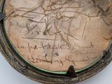 a close up of a clock with writing on it