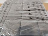 a mattress that is wrapped in plastic on top of a table