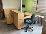 a desk with a chair and a computer on it