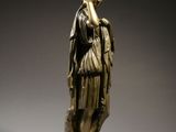 an image of a bronze statue of a woman standing on a pedestal